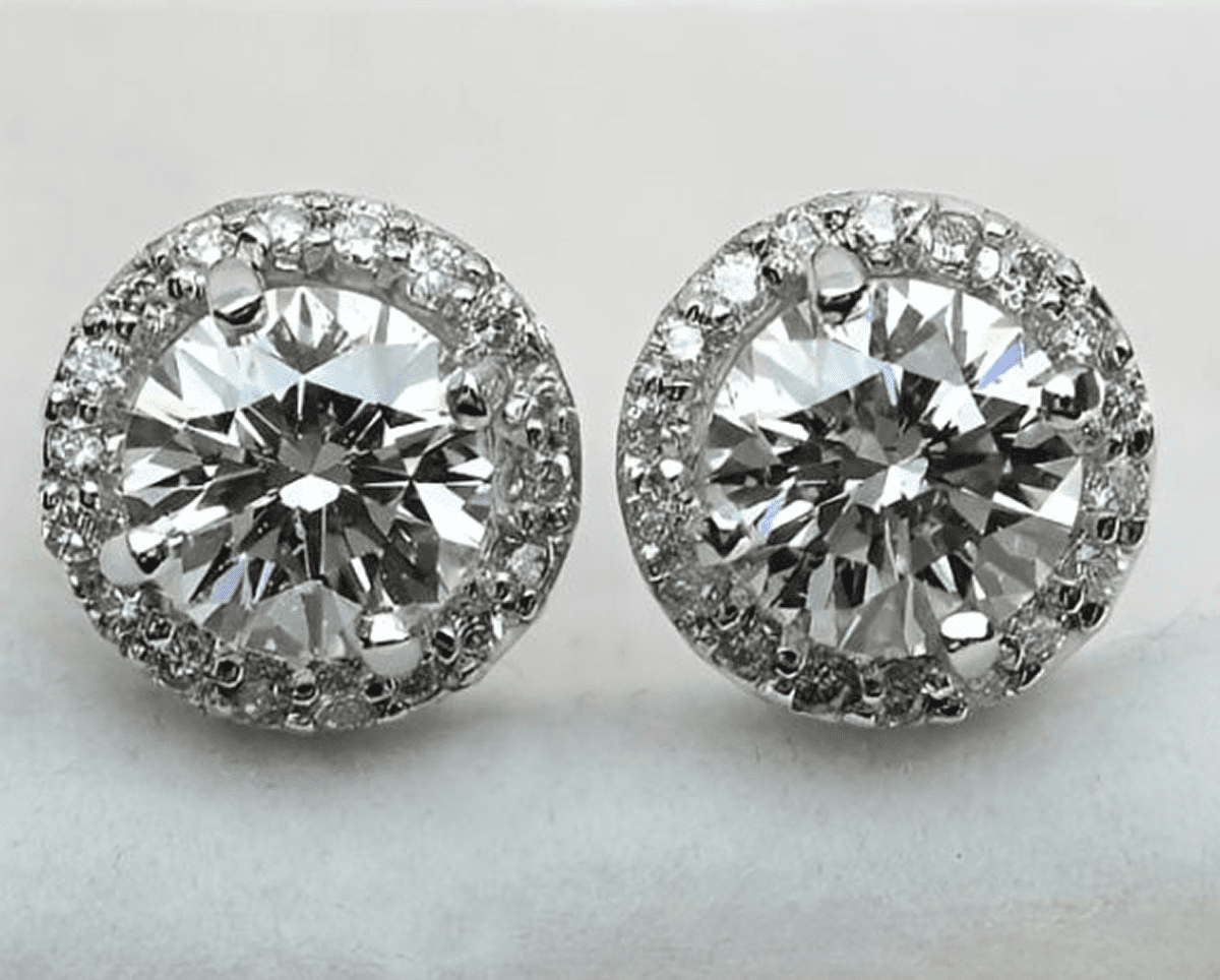 Diamond stud earrings with halo design.