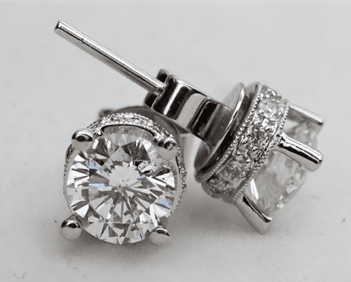 Diamond stud earrings on a white background.