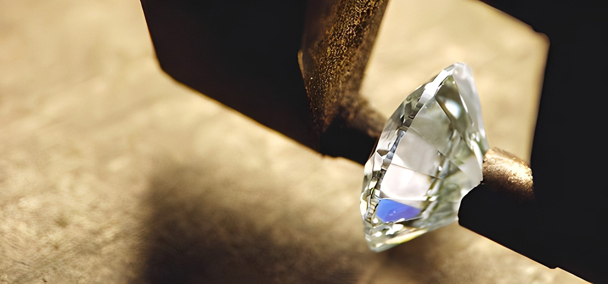 Diamond under magnifying glass on textured surface.
